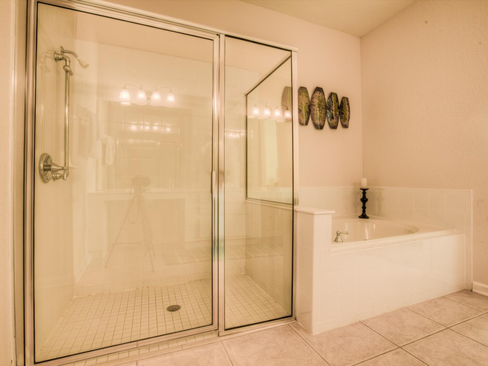 Relax and rejuvenate in the main bathroom's spacious layout, complete with a soothing bathtub and a convenient walk-in shower. Experience tranquility and comfort in every moment.