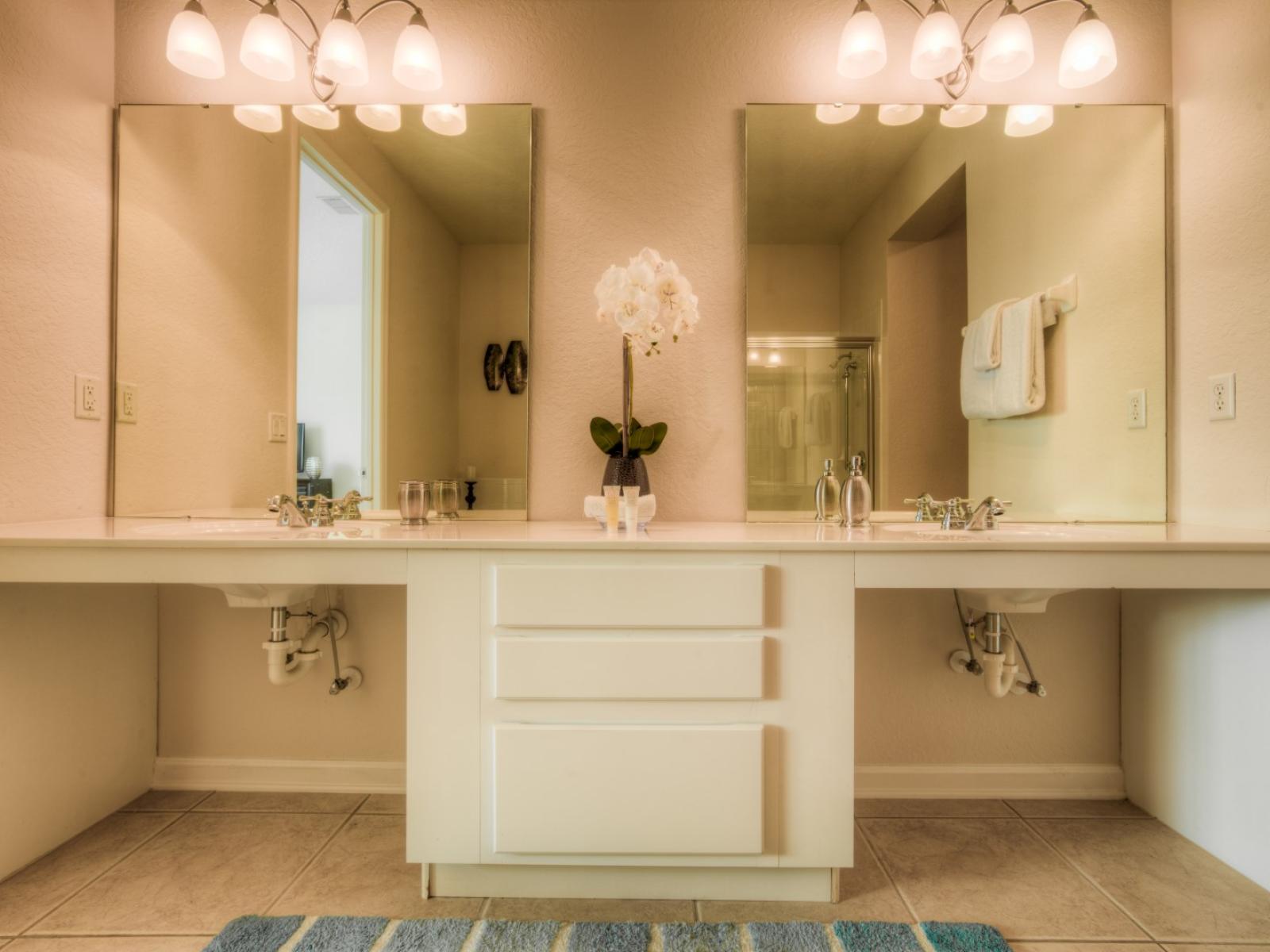 Step into the main bathroom's luxurious sanctuary, featuring a relaxing bathtub, a refreshing walk-in shower, and a sleek vanity area.