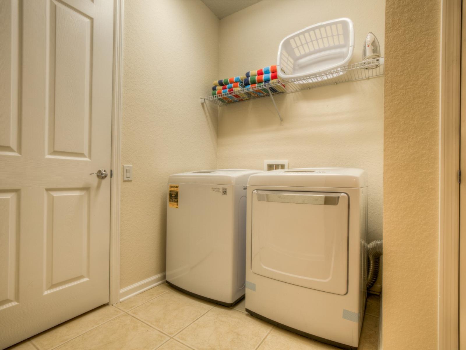 The laundry area boasts a full-size washer and dryer, ensuring that you can easily keep your clothes fresh and clean throughout your stay.