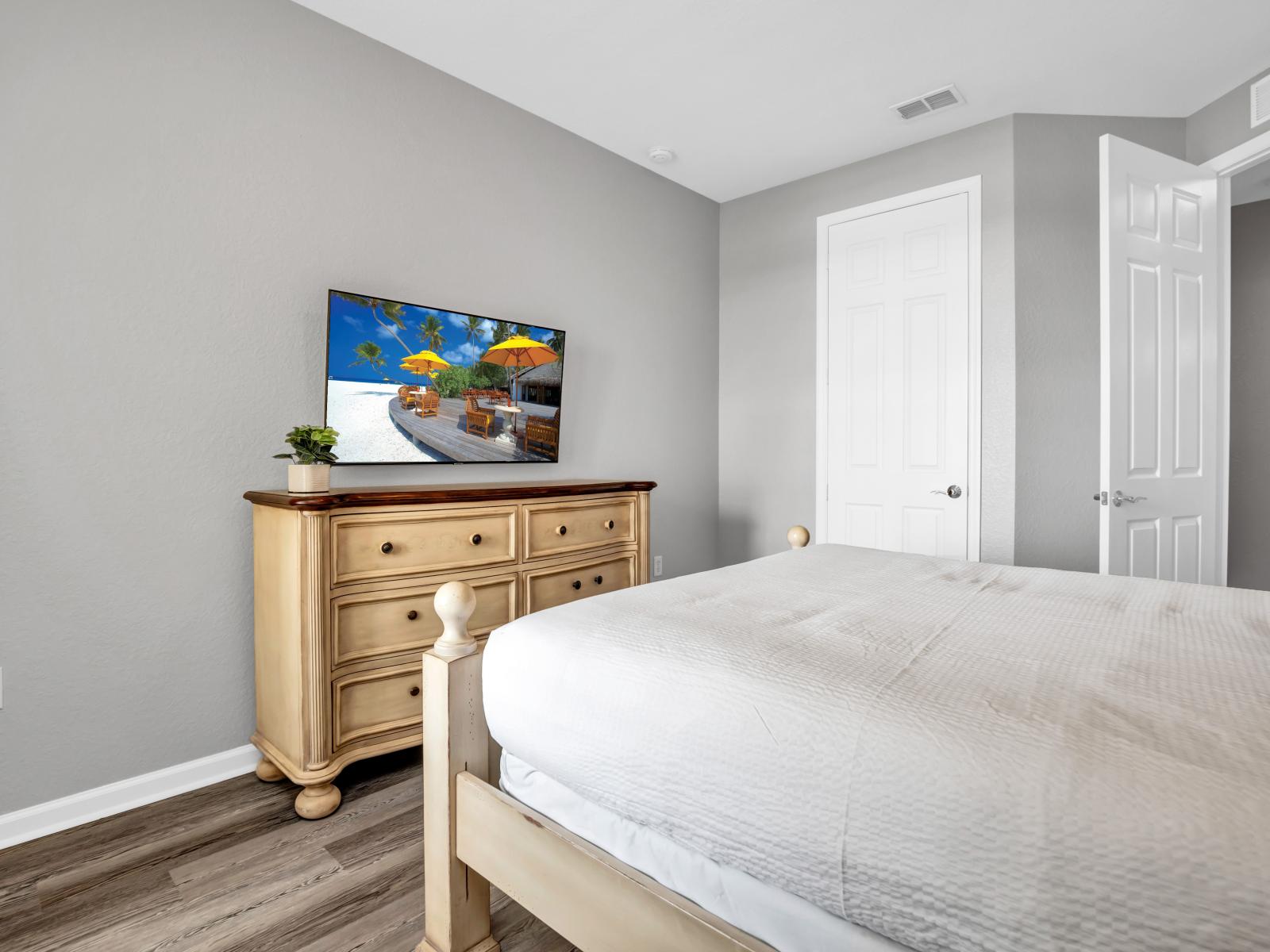 Experience vibrant comfort in this cozy bedroom, complete with a TV for your entertainment needs. Relax and unwind in style.