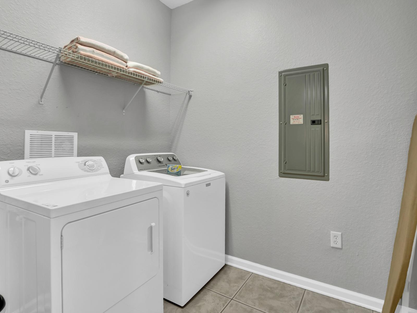 The laundry area boasts a full-size washer and dryer, ensuring that you can easily keep your clothes fresh and clean throughout your stay.