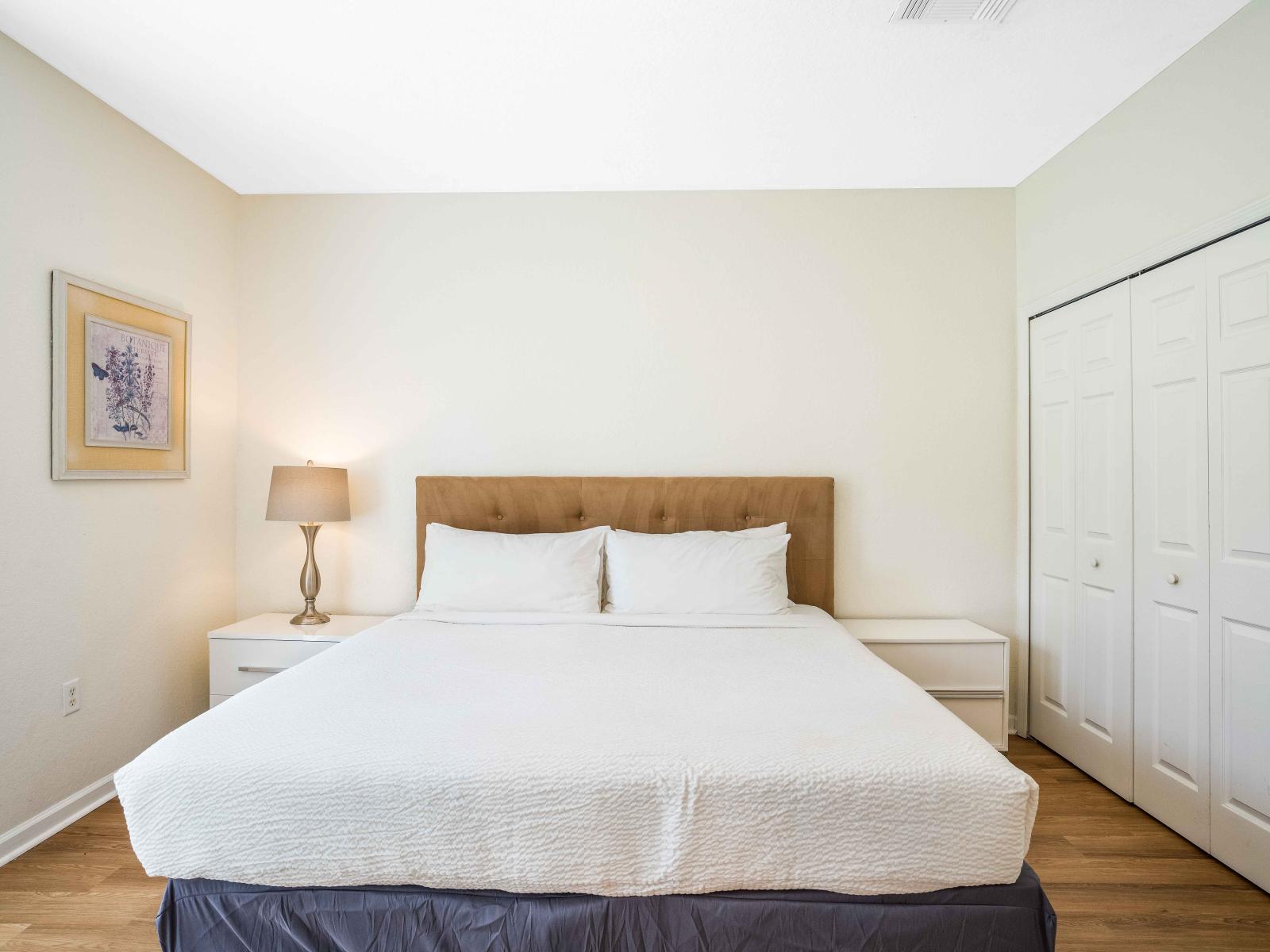 Sophisticated bedroom of the townhouse in Orlando - Beautiful white themed bedroom with a subtle brown bed frame double bed - Offering a sanctuary for peaceful and restful nights - Well-appointed wardrobe with sufficient storage space