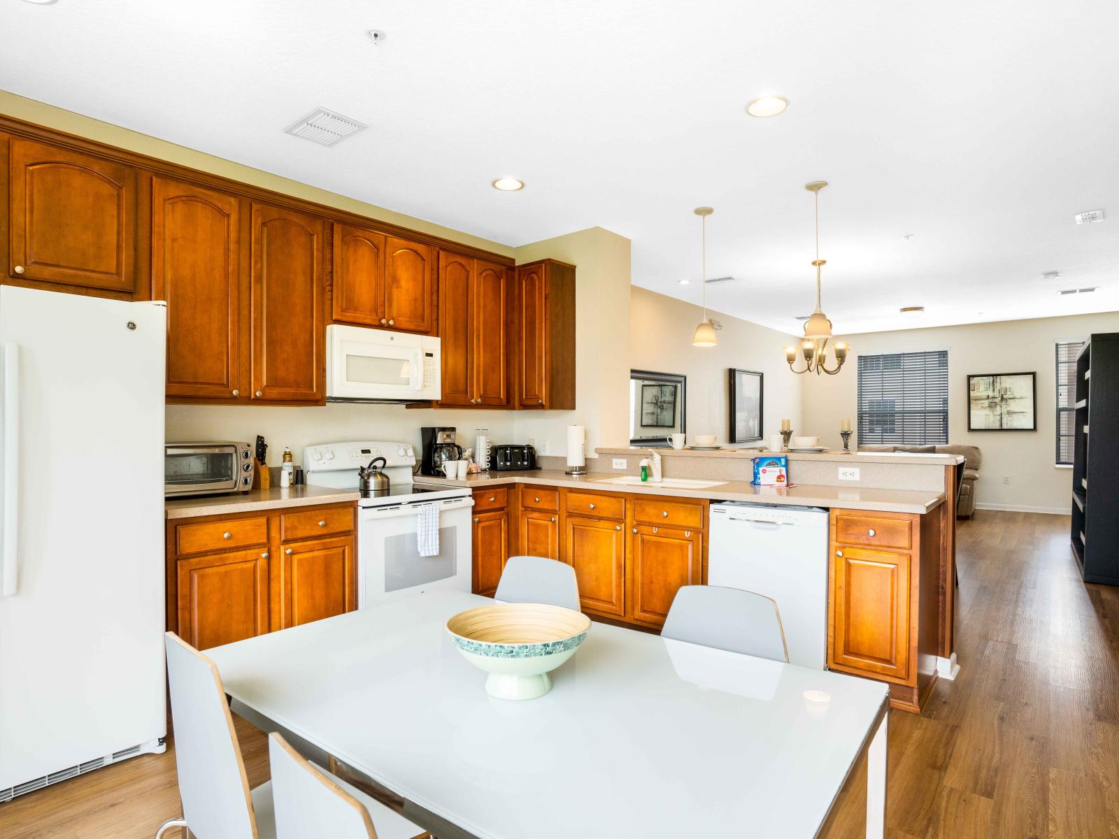 The Kitchen- adorned with rich wooden cabinets – where classic charm meets modern convenience, creating a culinary sanctuary that exudes warmth and sophistication.