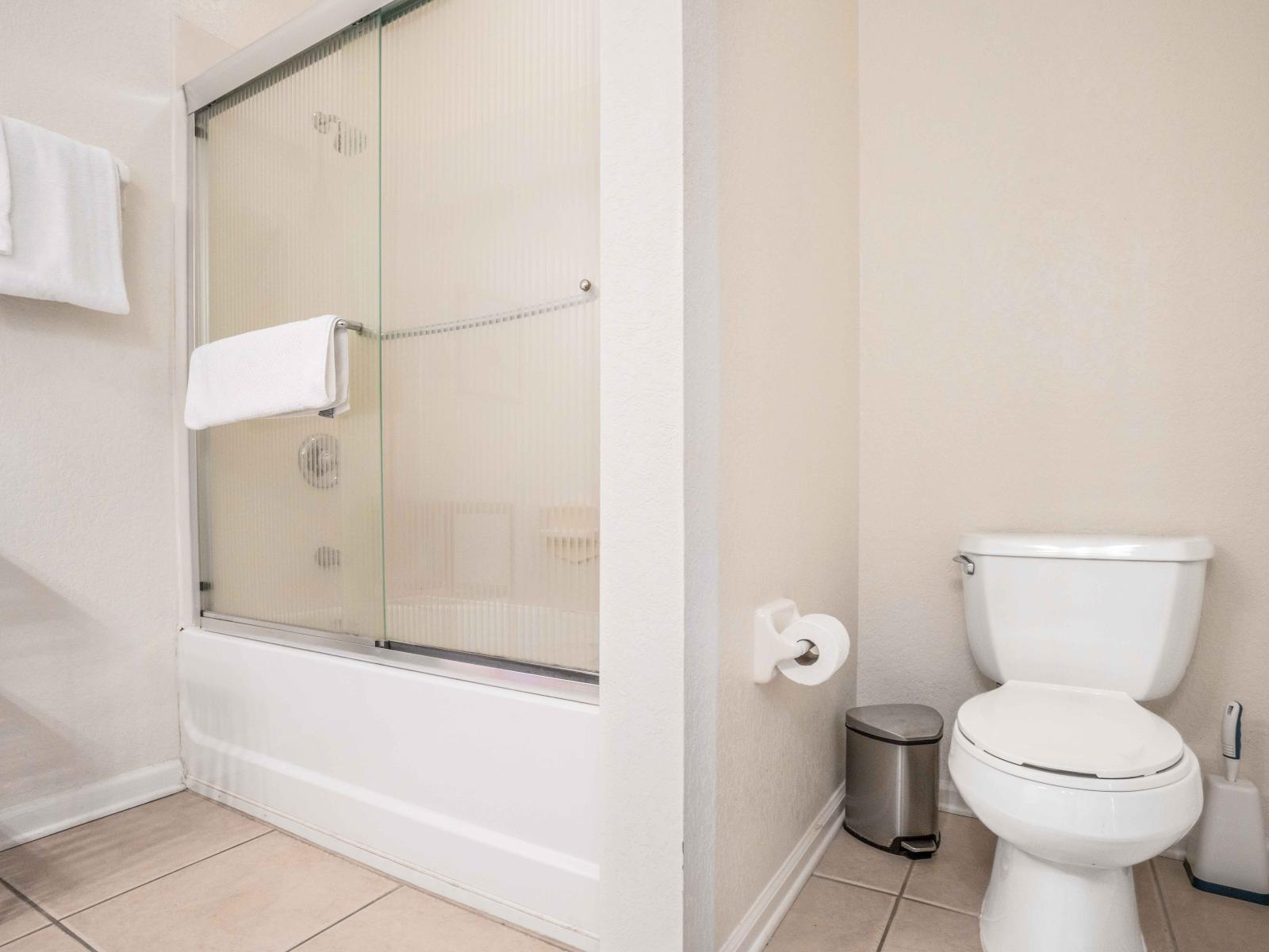 EnSite bathroom with cozy toile seat, glass enclosed shower area. Fresh and cozy towels to keep yourself fresh