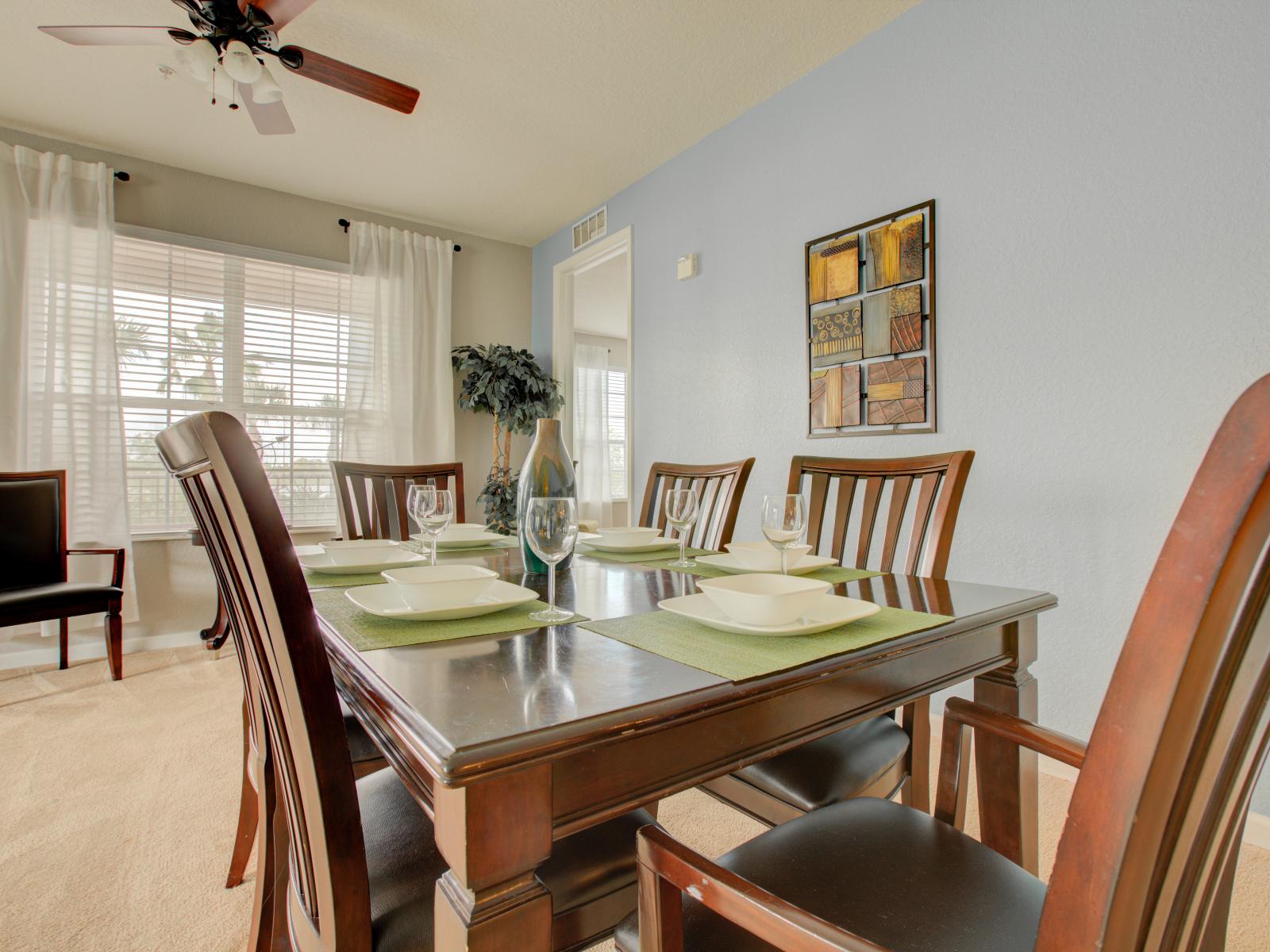 Sunlit Elegance: A 6-Seater Dining Table Bathed in Natural Light, Nestled Beside Big Windows to Enhance Your Dining Experience.