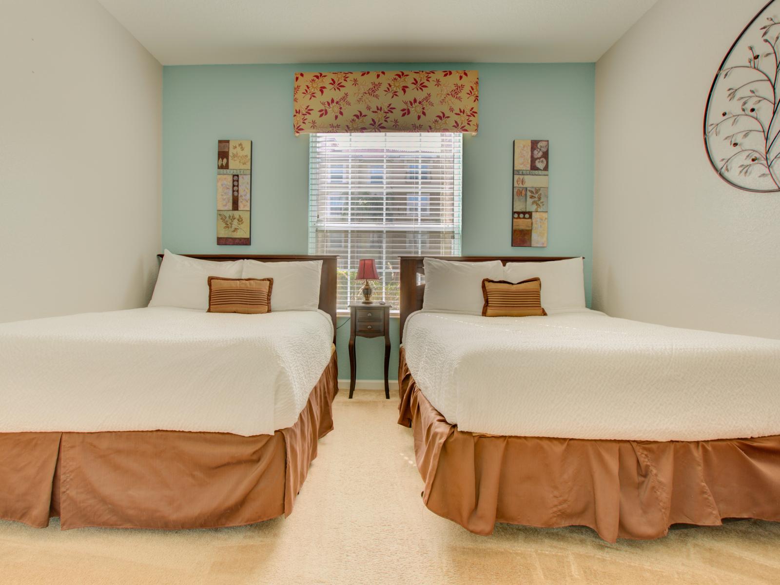 Relax and unwind in our inviting bedroom with two beds. Perfect for families or friends traveling together, this cozy space offers double the comfort for a restful night's sleep.