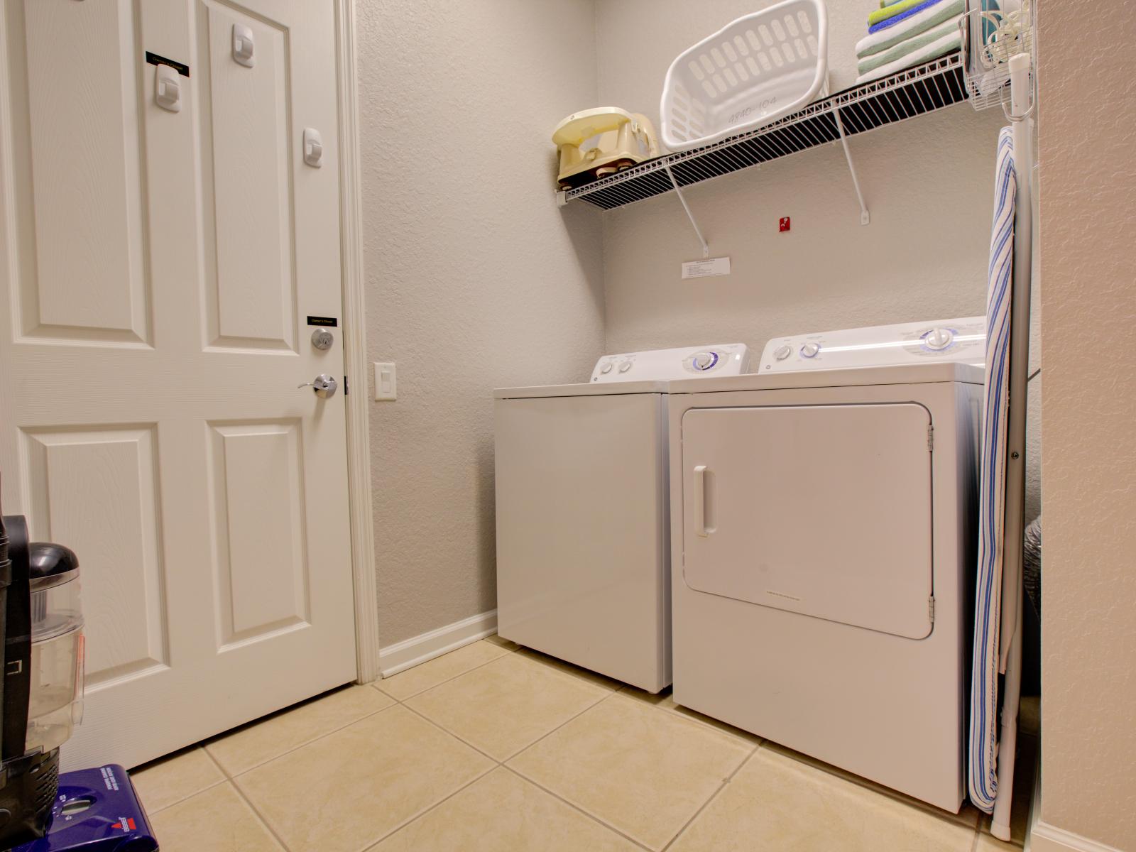 The laundry area boasts a full-size washer and dryer, ensuring that you can easily keep your clothes fresh and clean throughout your stay.