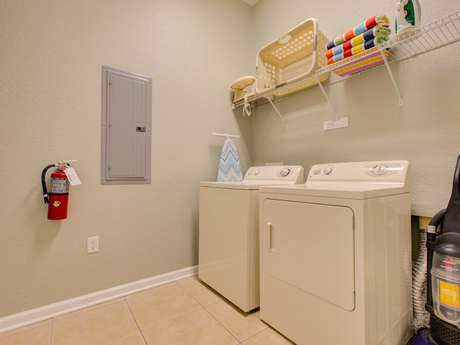 The laundry area boasts a full-size washer and dryer, ensuring that you can easily keep your clothes fresh and clean throughout your stay.