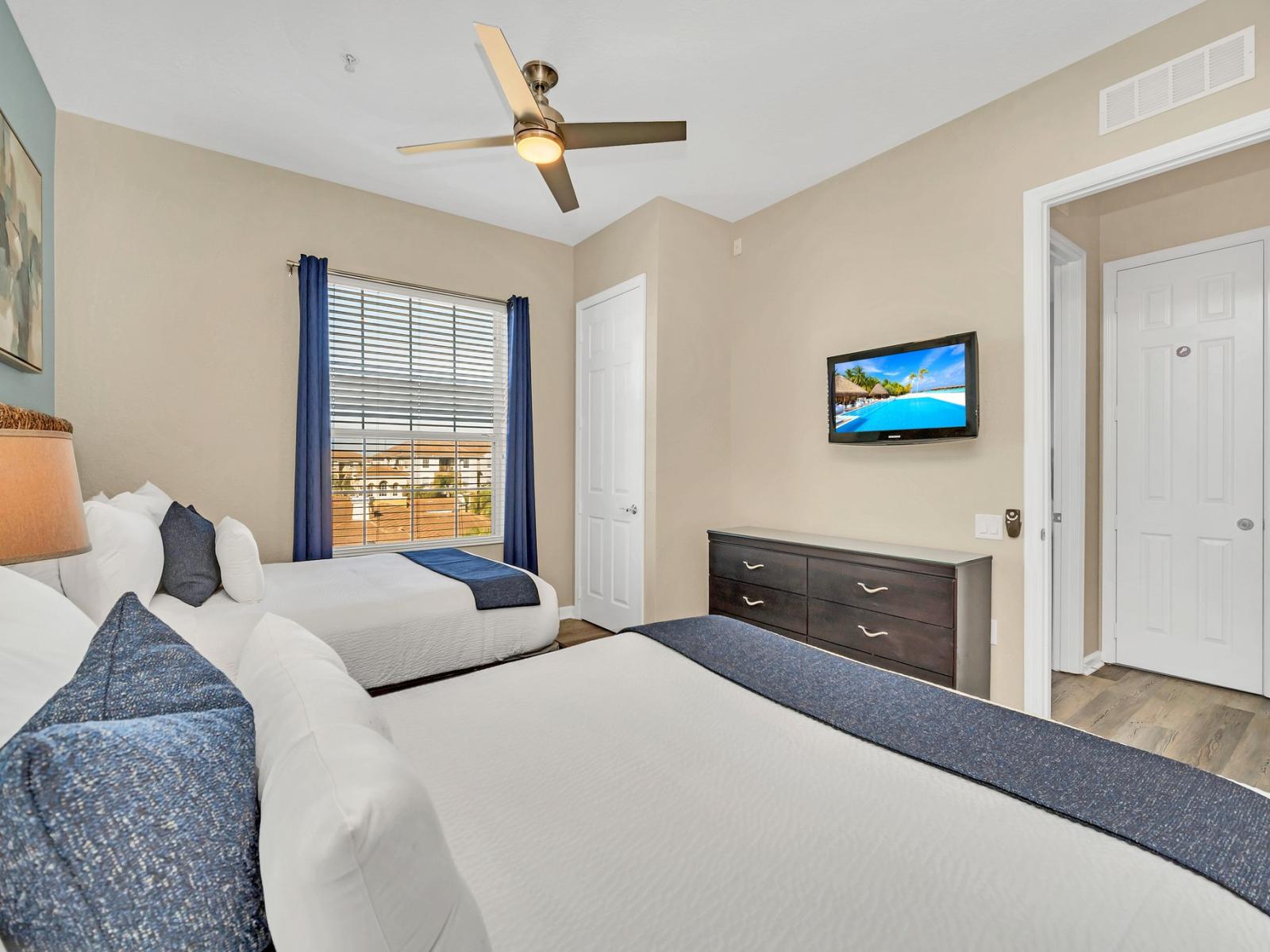 Shared Serenity: This bedroom with two beds offers a tranquil space for companionship and relaxation, where shared dreams and cherished moments intertwine amidst comfort and warmth.