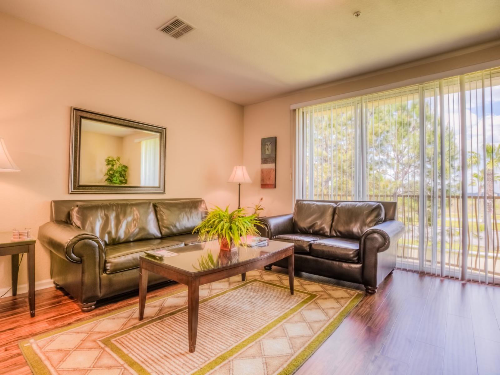 Spectacular Living area of the Townhouse in Orlando - Unwind in the comfort of our townhouse living area with cozy sofas - Stunningly located private balcony - Majestic decor with large size wall mirror and wall pintings