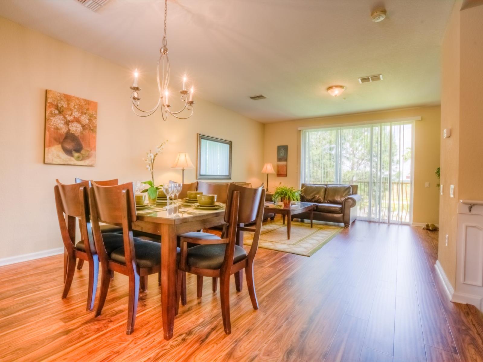 Sublime dinning area of the townhouse in Orlando - A perfectly organized space to enjoy your meals with beautiful decor - Majestic chandelier and aesthetic wall painting enhancing the space beauty - Elite 6 persons dinning table