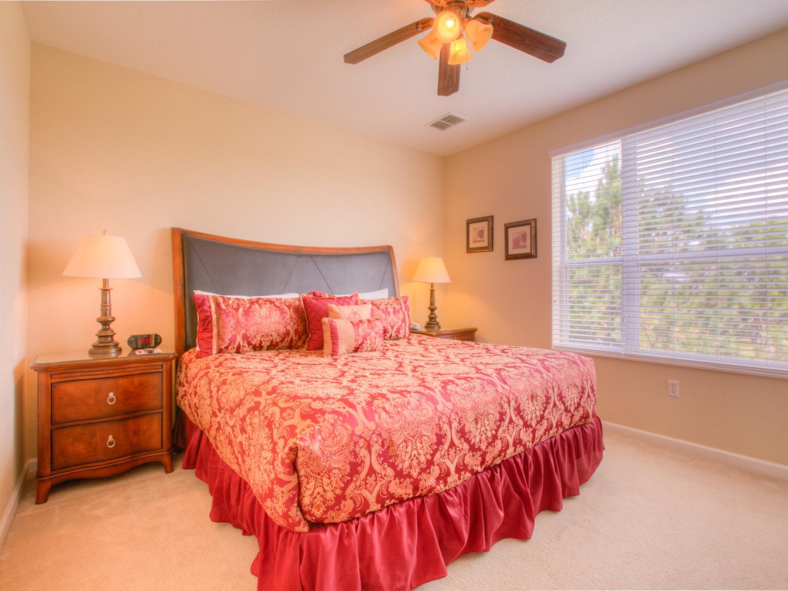 Sophisticated bedroom of the townhouse in Orlando - Comfortable double bed -  Stunningly carpeted floor - Majestic table lamps and beautiful fan with lamp - Gloriously designed bedside window with mesmerizing outside views