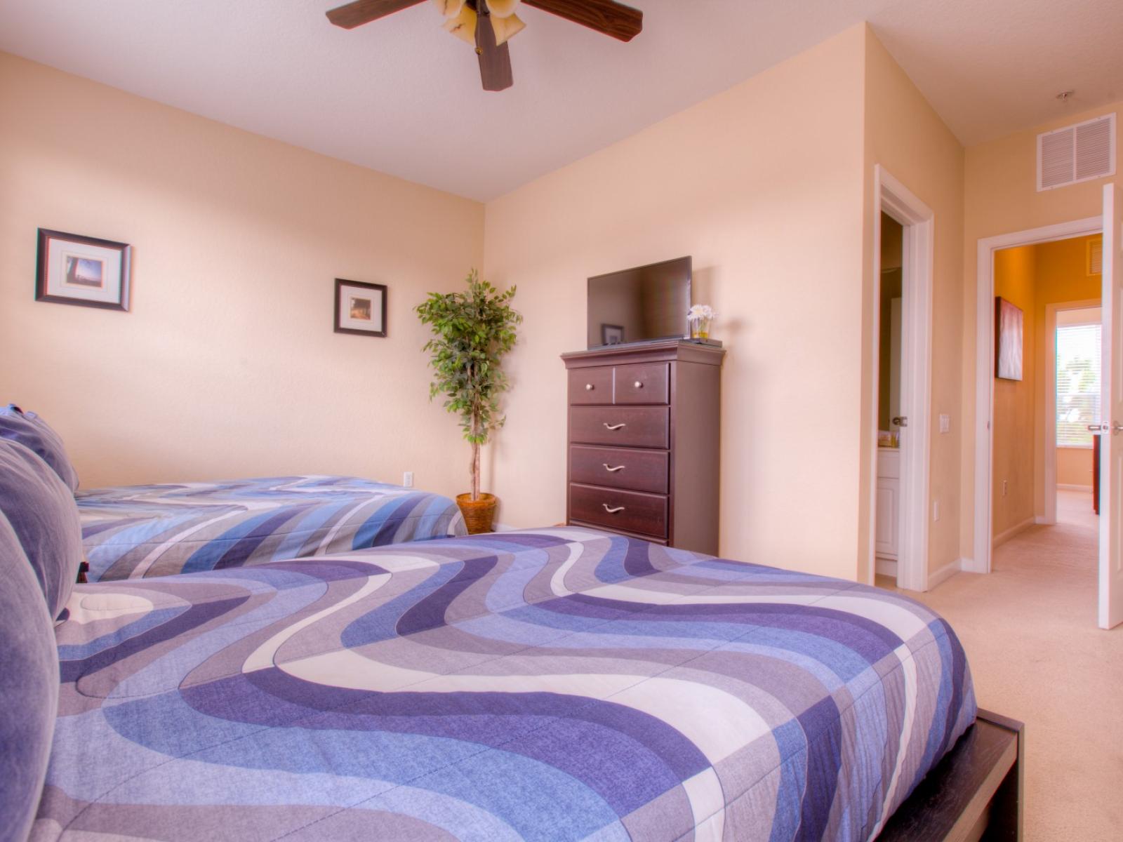 Glorious bedroom of the townhouse in Orlando -  Amazing ambiance with majestic decor - Cozy beds with neat and clean linen - Availability of smart TV -  Amazingly designed large wardrobe with sufficient storage space