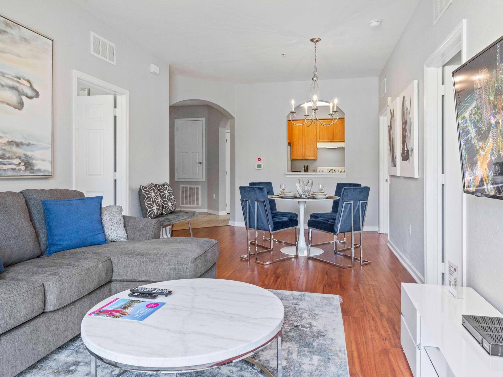 The kitchen, living, and dining areas merge seamlessly, creating a vibrant hub where cooking, relaxation, and dining converge, fostering a sense of togetherness and comfort.