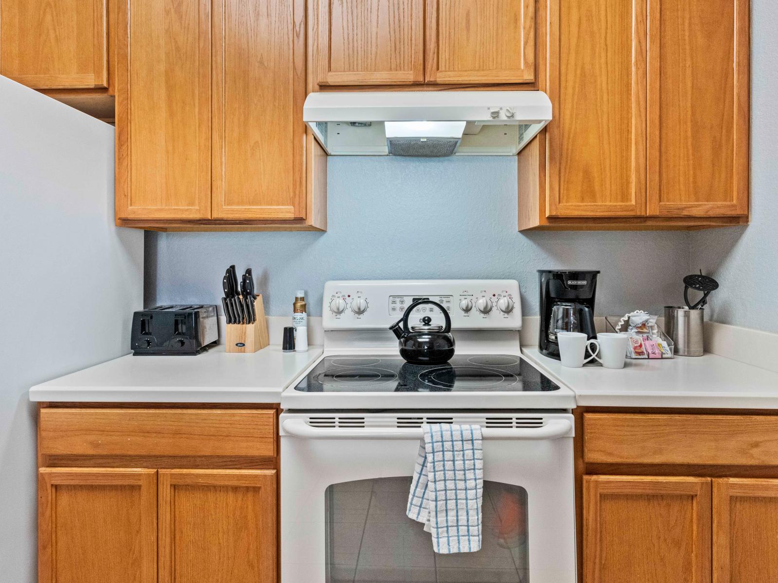 The kitchen adorned with wooden cabinets  exudes rustic elegance, blending natural charm with modern functionality for a warm and inviting culinary space.