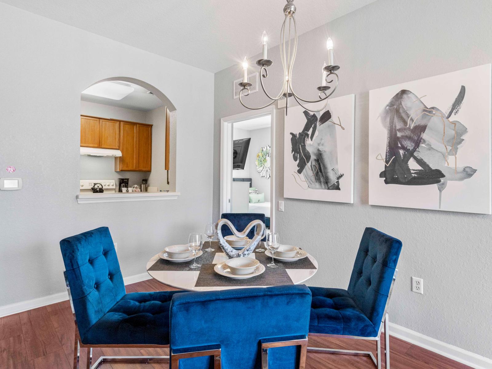 The elegant dining area, adorned with exquisite lights and fixtures, exudes refined charm and timeless beauty.