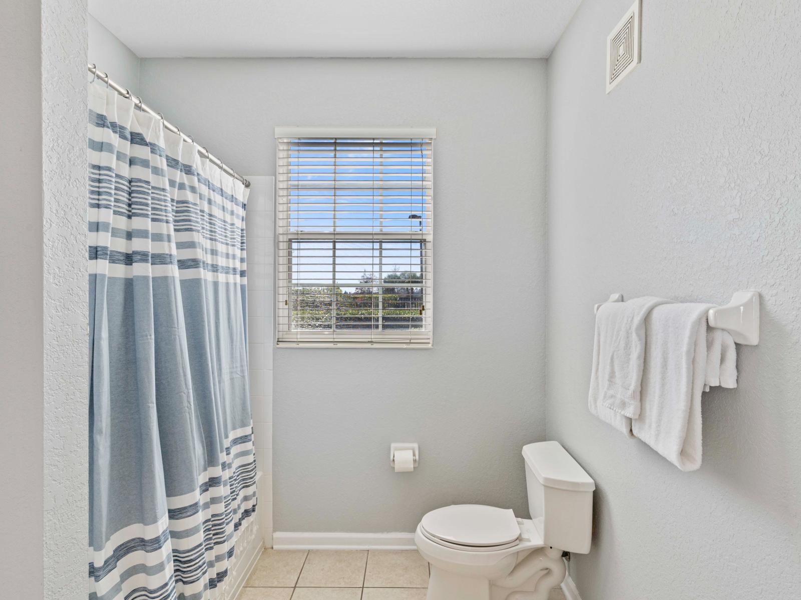 Unwind in the lavish en-suite bathroom of our King Suite, featuring a spacious layout, modern fixtures, and a rejuvenating ambiance.