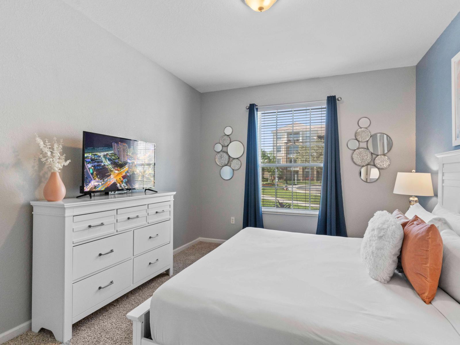 Relax in this inviting bedroom retreat, complete with a TV for your viewing pleasure. Unwind in comfort and style as you enjoy your favorite shows and movies in this cozy sanctuary.