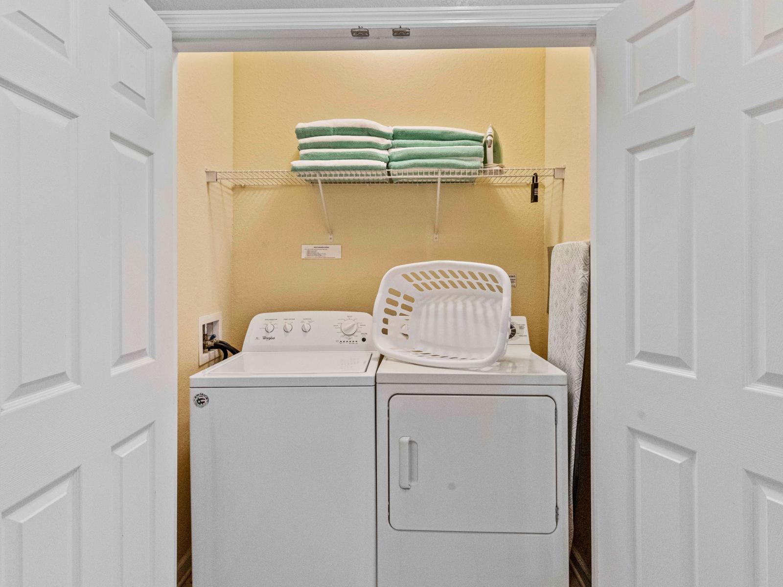 The laundry area boasts a full-size washer and dryer, ensuring that you can easily keep your clothes fresh and clean throughout your stay.