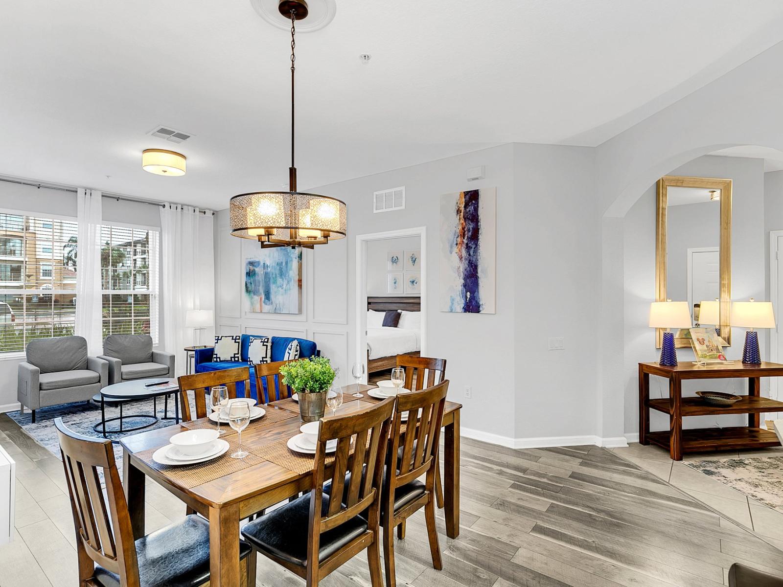 Bask in the gentle glow of elegance - our dining and living area, adorned with white light fixtures, illuminates moments of togetherness and tranquility.