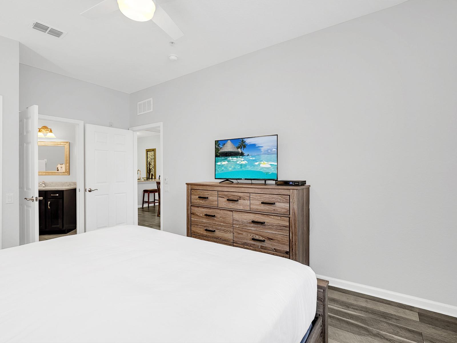 Experience the perfect blend of relaxation and entertainment in our cozy room, complete with a charming wooden cabinet and TV for your viewing pleasure.