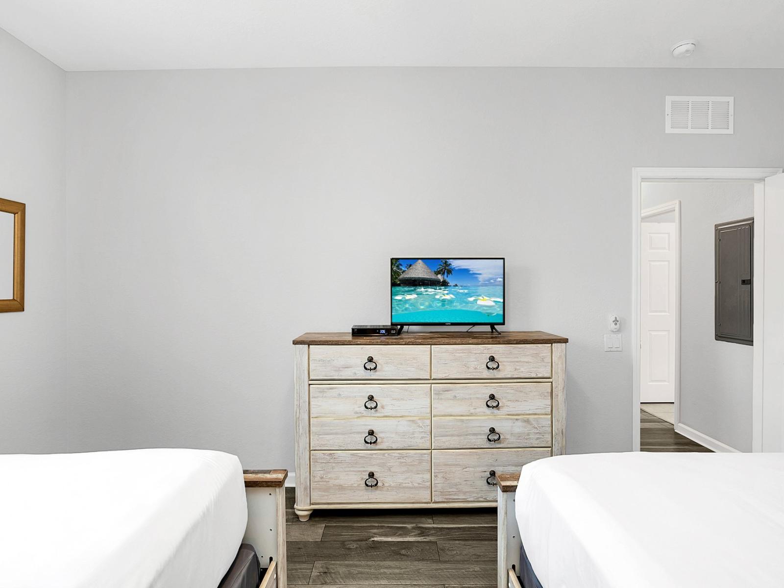 Unwind in style in our cozy two-bed bedroom, where relaxation meets entertainment with a convenient TV setup.