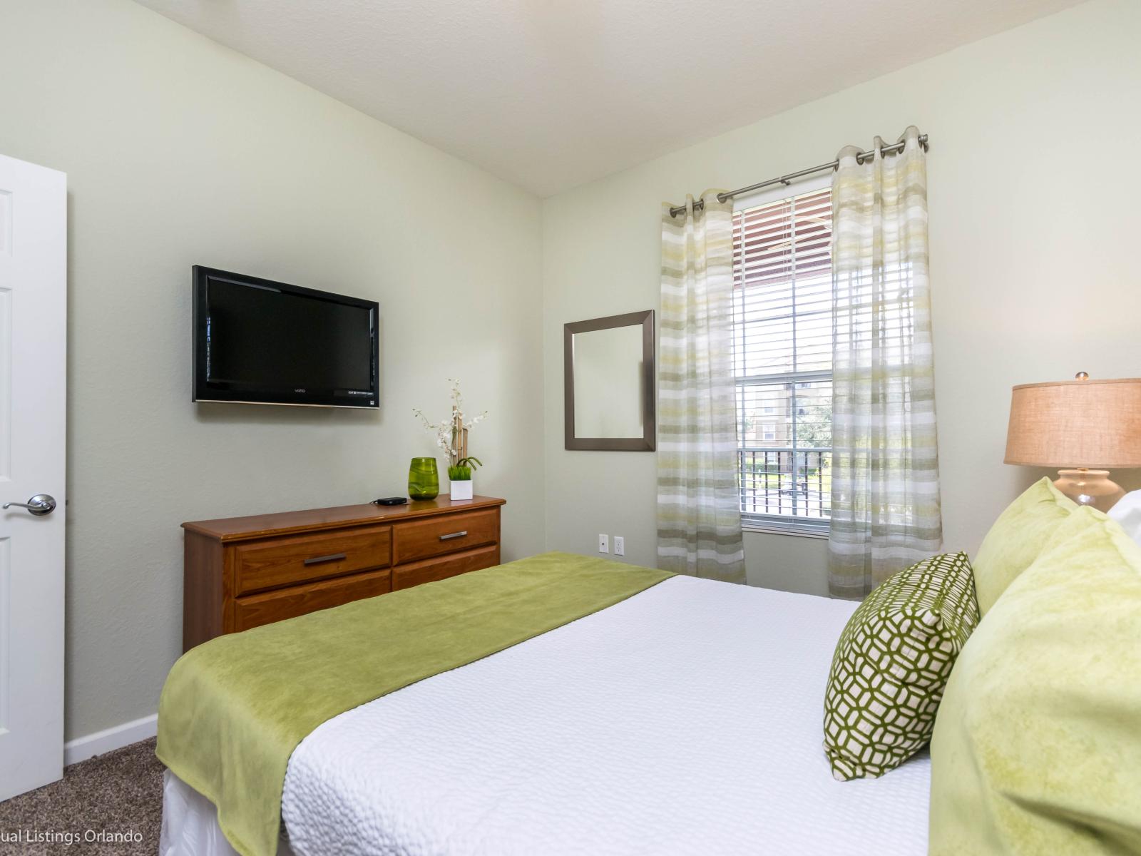 This bedroom, complete with a cozy side table and lamp, creates a soothing retreat where the gentle glow invites relaxation and bedtime stories unfold in the comfort of your own personal haven.