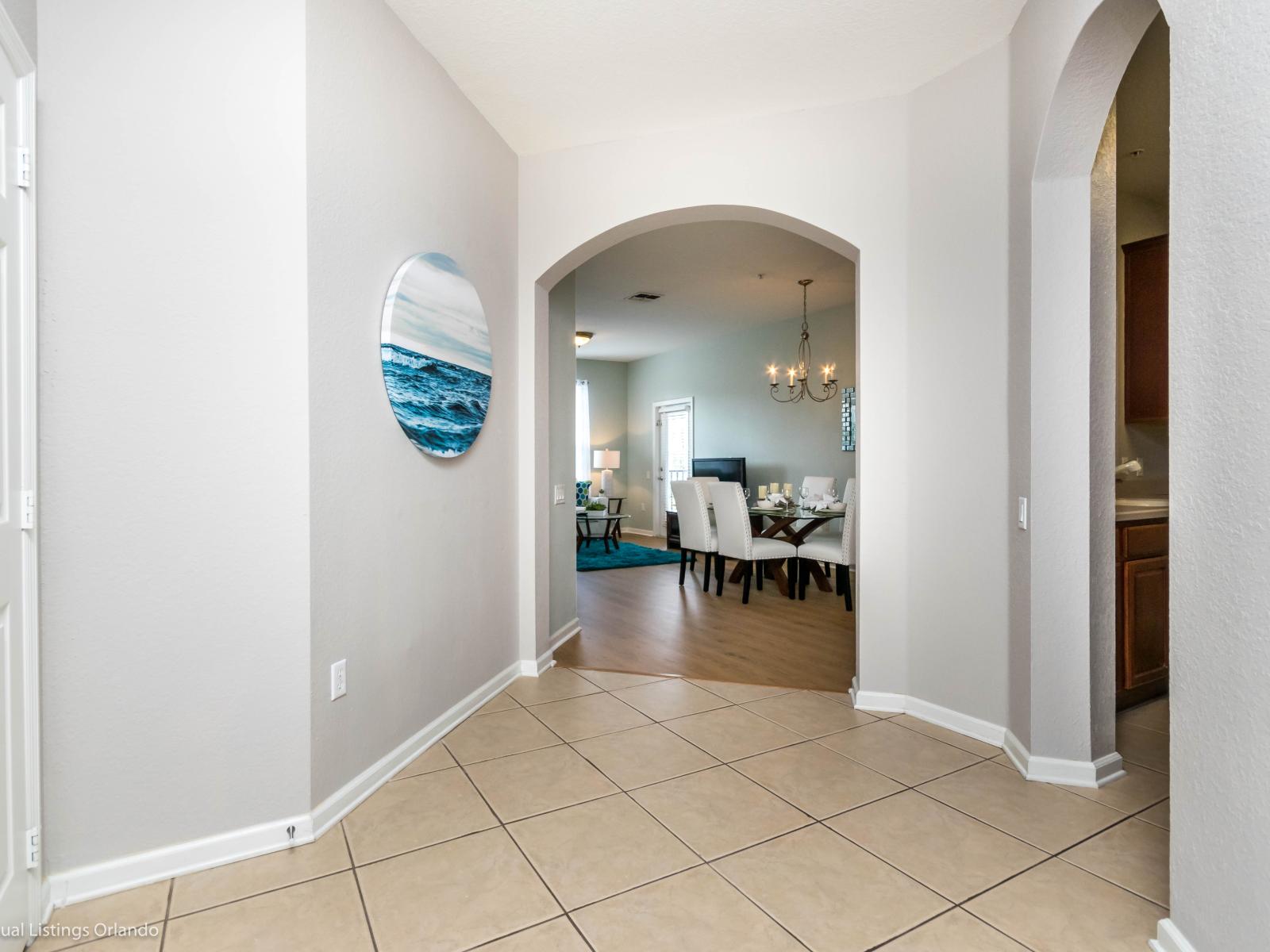 : Traverse through the hallway leading to the heart of the condo, where the kitchen, dining, and living areas seamlessly blend together, promising a delightful experience for all.