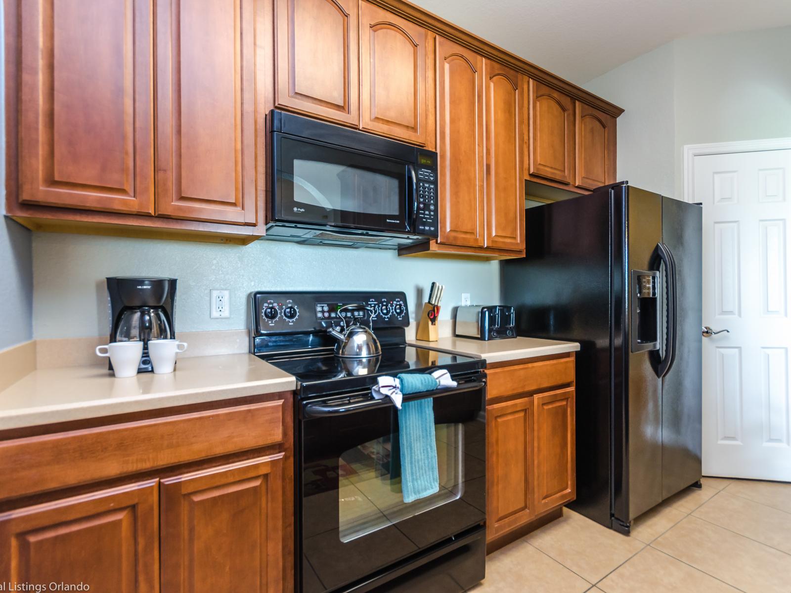 Crafted Elegance: Our kitchen adorned with wooden cabinets combines timeless charm with modern functionality, creating a warm and inviting space to inspire culinary creativity.