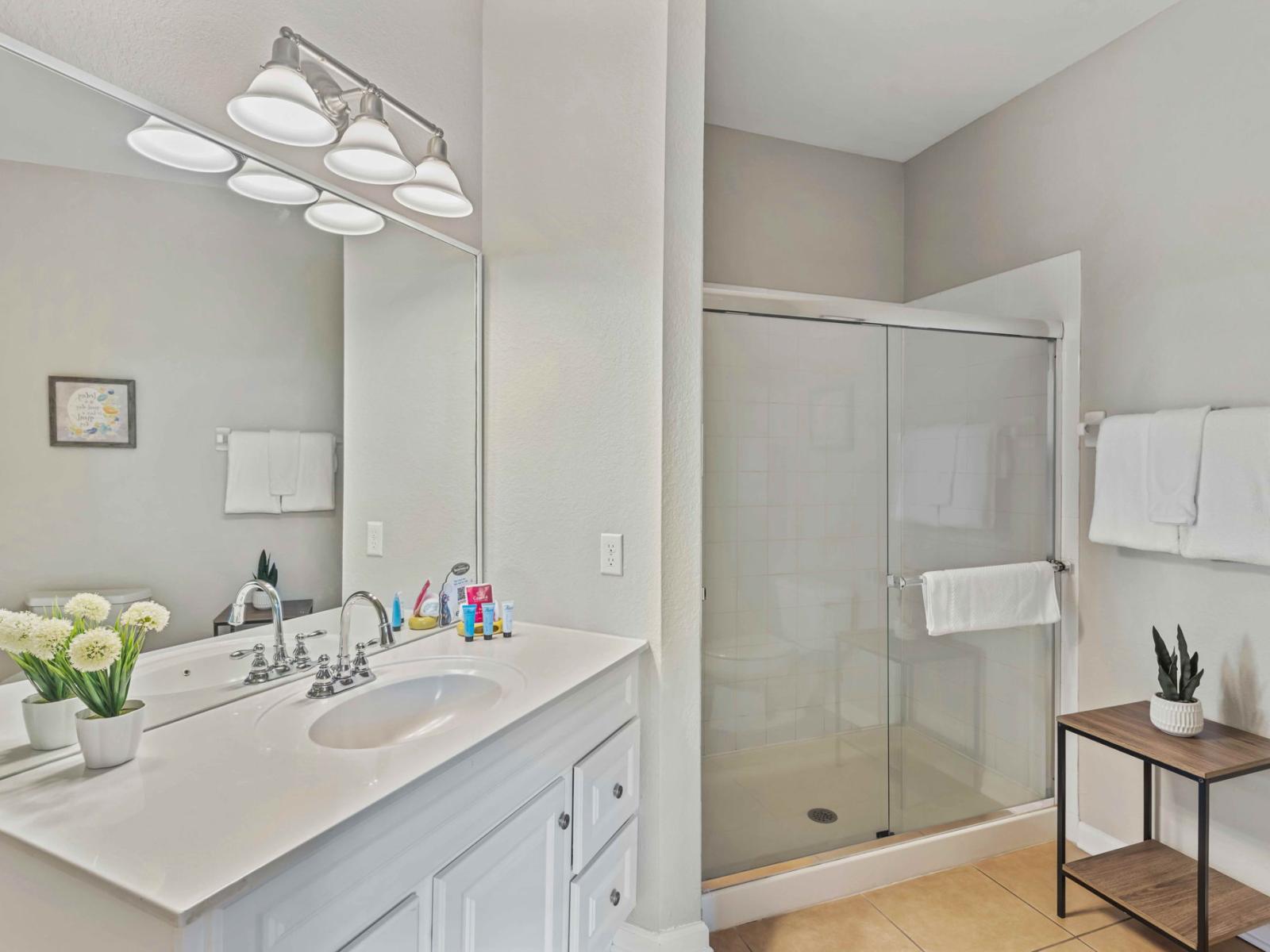 Walk into Relaxation: Our Airbnb bathroom invites you to indulge in a modern retreat, complete with a spacious walk-in shower for a luxurious bathing experience