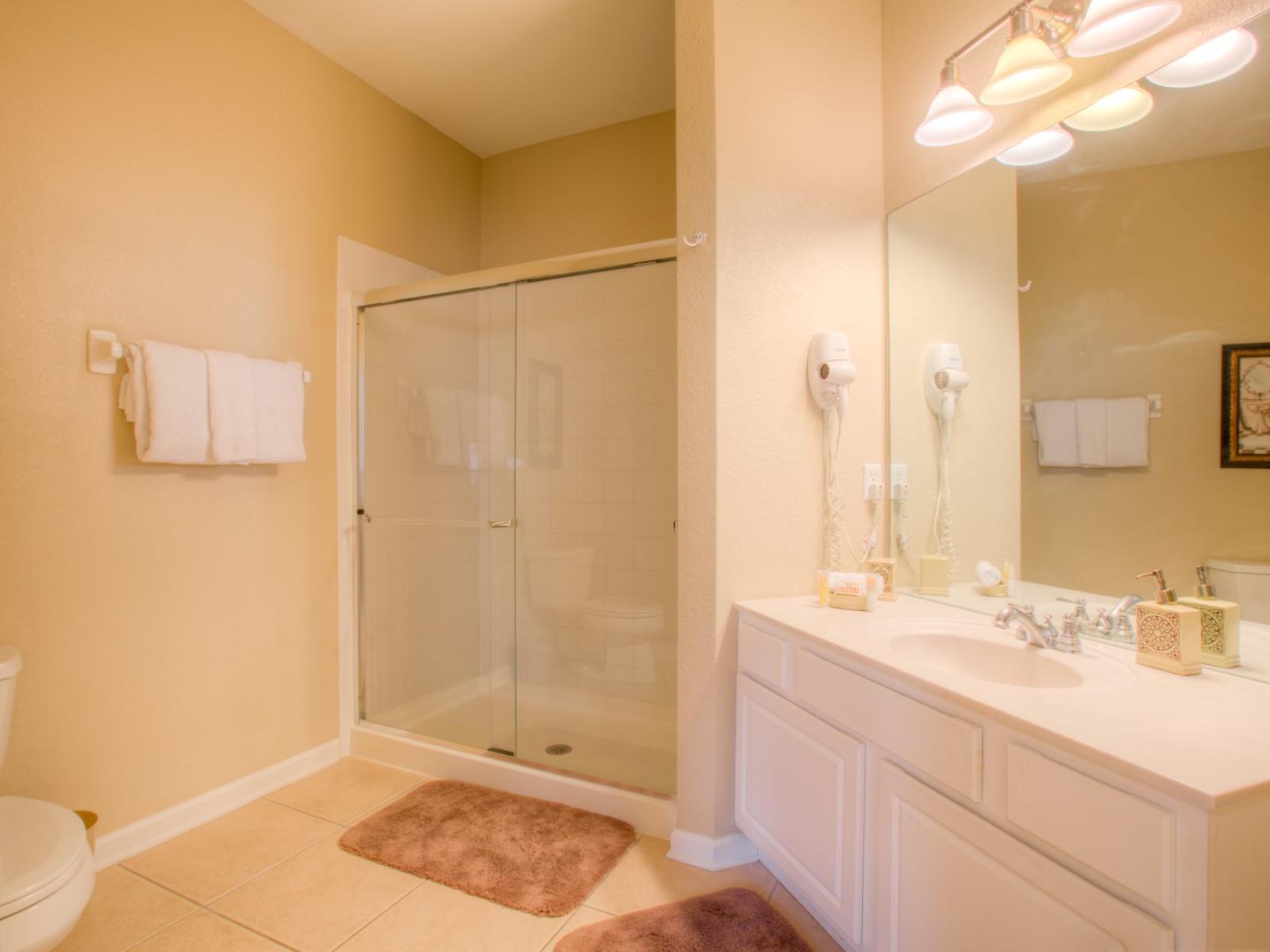 Lavish Bathroom of the Apartment in Orlando Florida - Chic design featuring a sleek vanity and upscale lighting - Spacious layout offering a sense of - An ensuite bathroom with a walk in shower with pure tranquility