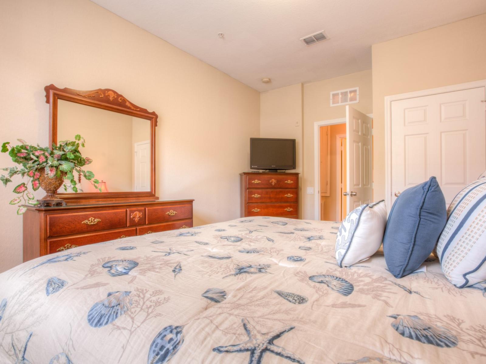 Plush Bedroom of the Apartment in Orlando Florida - Comfy king Size Bed - Bedroom adorned with crisp white and calming blue beddings - Dreams are painted in hues of comfort and relaxation - A peaceful haven awaits