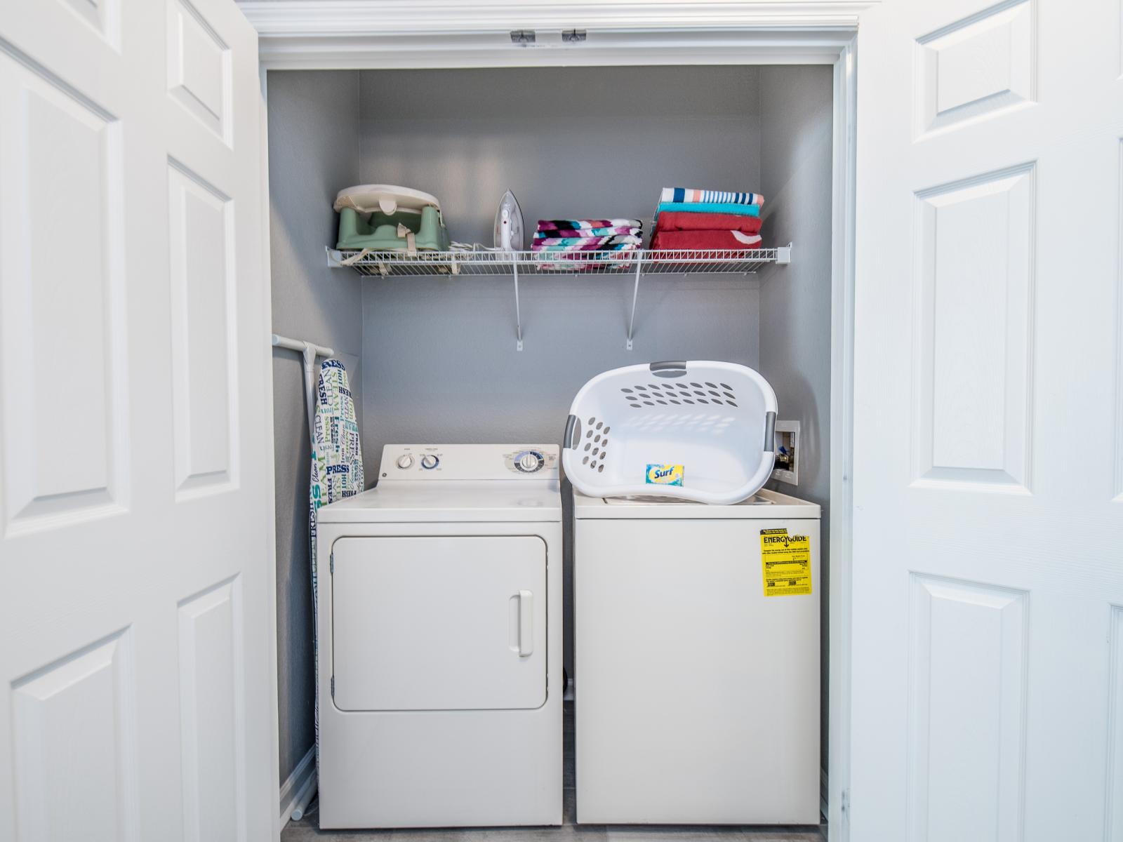 The laundry area boasts a full-size washer and dryer, ensuring that you can easily keep your clothes fresh and clean throughout your stay.