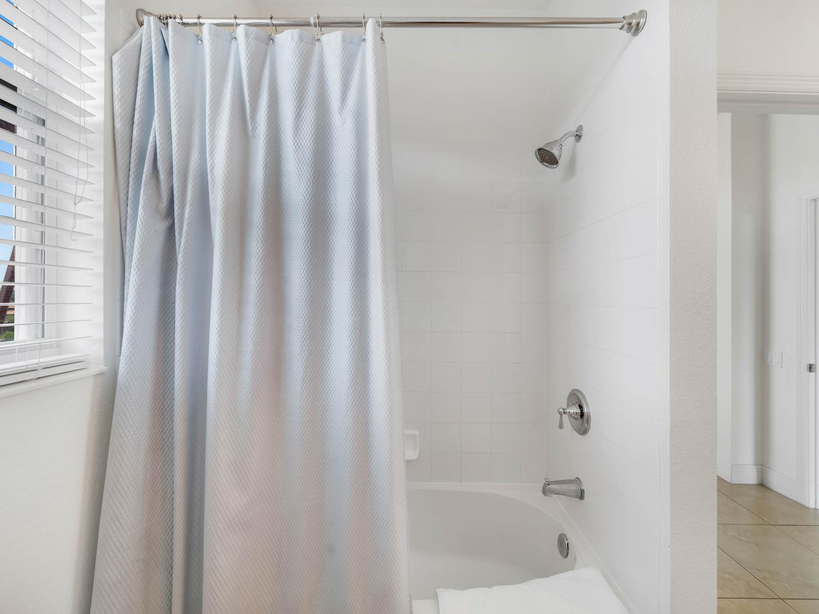 Bathroom 2 with a bathtub and a shower combo