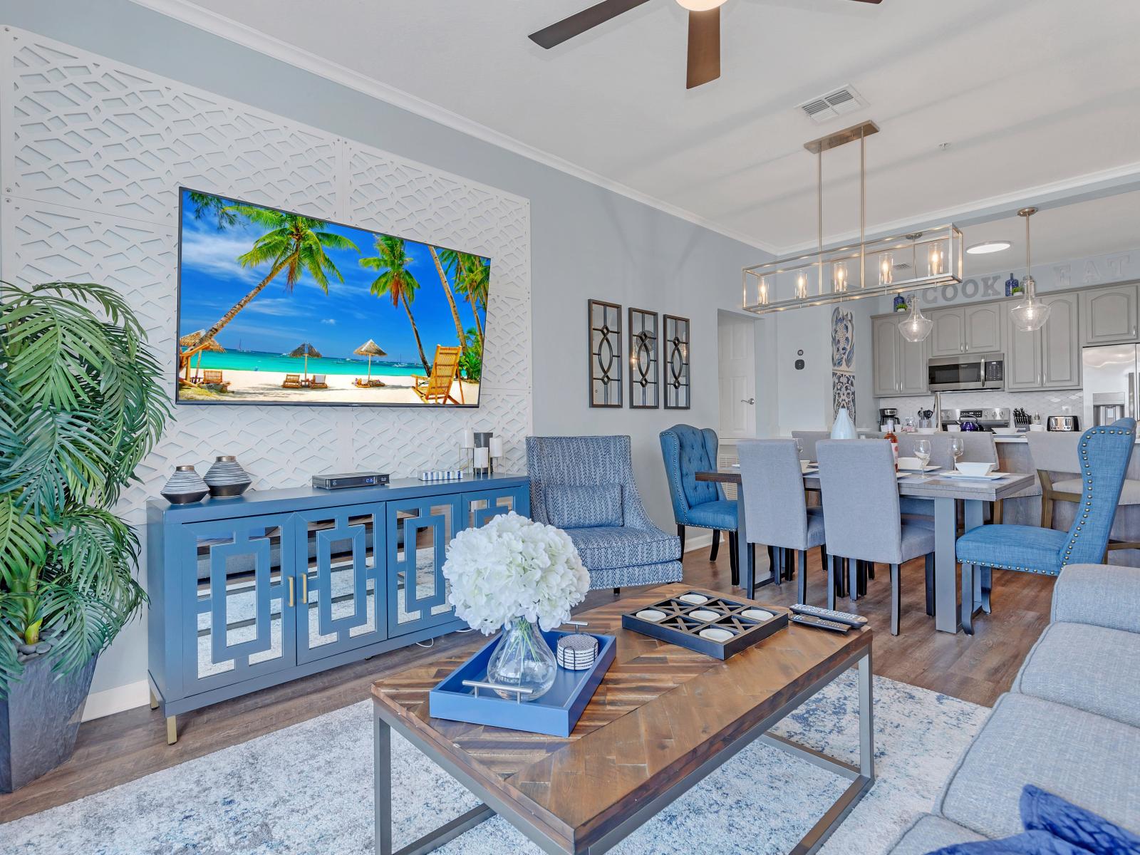 Sunny living room with big 75" smart TV.