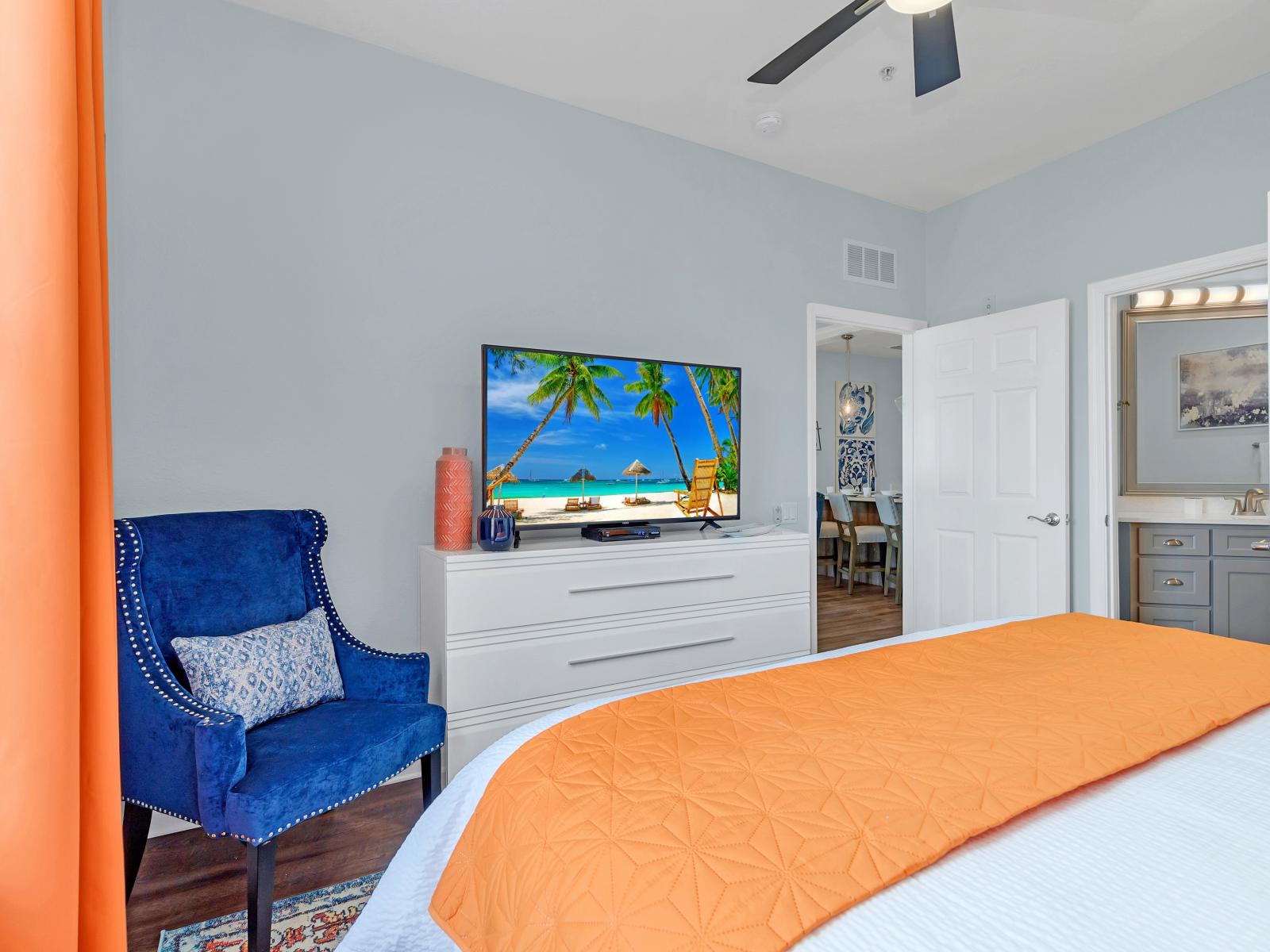 Main bedroom with king bed, big 65" smart TV and private bathroom