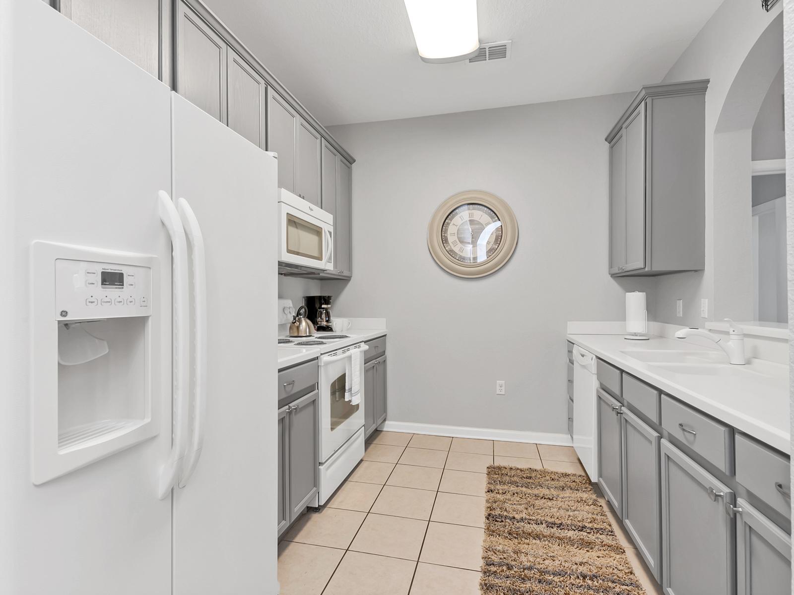 Gourmet kitchen of the condo in Orlando Florida - Contemporary design with clean lines and minimalist aesthetics - Smart use of space with versatile storage solutions - Fully equipped with all kitchen accessories and stainless steel appliances