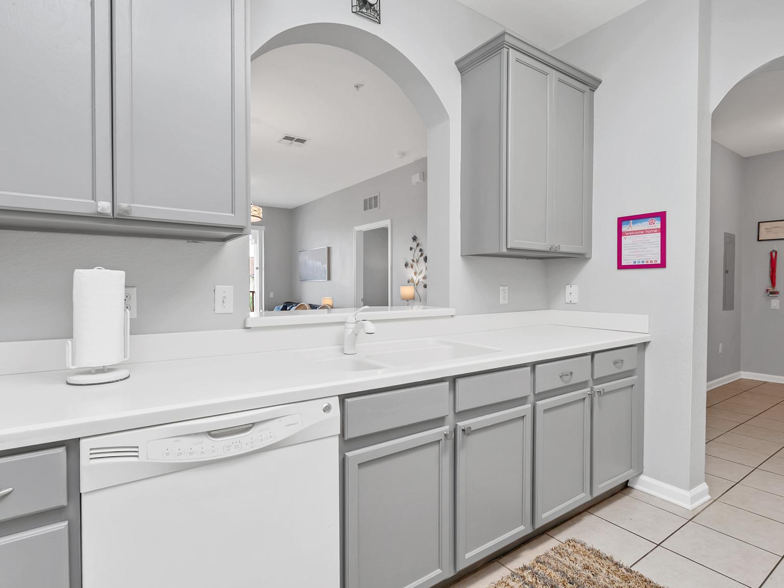 - Gourmet Kitchen of the condo in Orlando Florida - A fully Equipped kitchen where you can enjoy cooking and prepping your meals - Availability of high chairs at the Breakfast bar -Elegant white and grey themed kitchen - Plenty of storage space