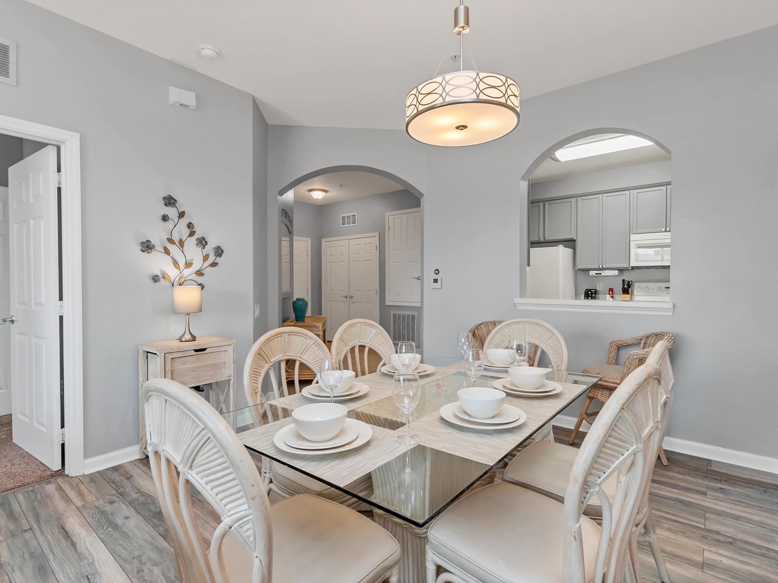 - Stylish Dining Area of the condo in Orlando Florida - The six seater dining table under a majestic hanging lamp - Fronting the living area and kitchen which is an easy access to serve your food - Elegant Decor