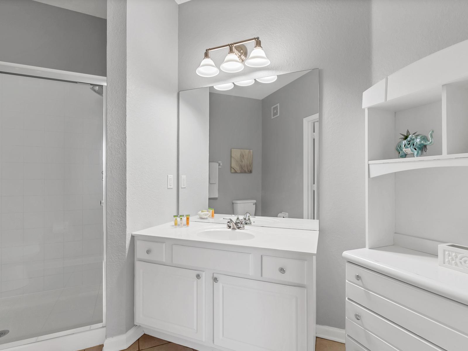 - Classy Bathroom of the condo in Orlando Florida - Discover the pinnacle of tranquility - Complete with a luxurious and a sleek walk-in shower for a spa-inspired retreat - Lush vanity with large mirror and plenty of storage