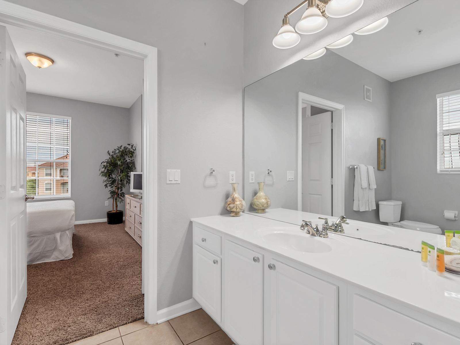 - Gorgeous Bathroom of the condo in Orlando Florida - Space with strategically placed mirrors for a spacious feel - Contemporary fixtures for a touch of indulgence - Seamless design featuring Lovely twin sink vanity and shower area