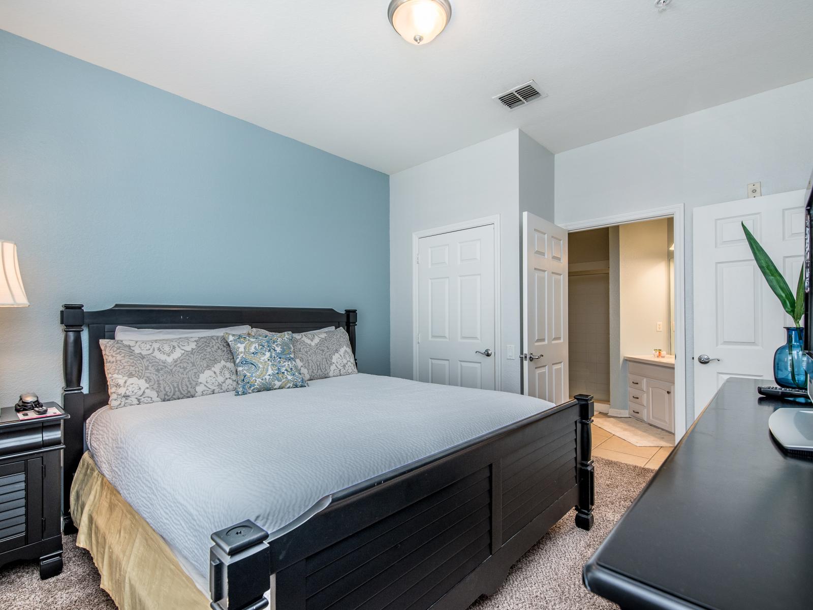 Relax in comfort in this spacious master bedroom, complete with a TV for entertainment and an ensuite bathroom for added convenience and privacy.