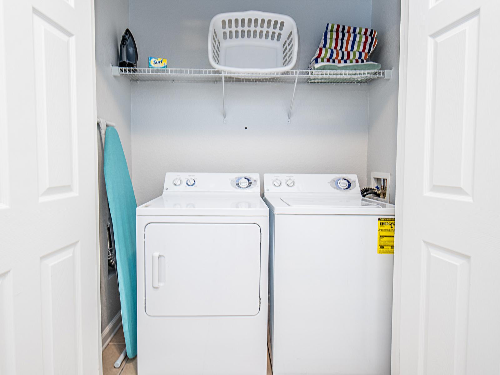 Behold the laundry area equipped with a full-size washer and dryer, offering convenience and efficiency for all your laundry needs.