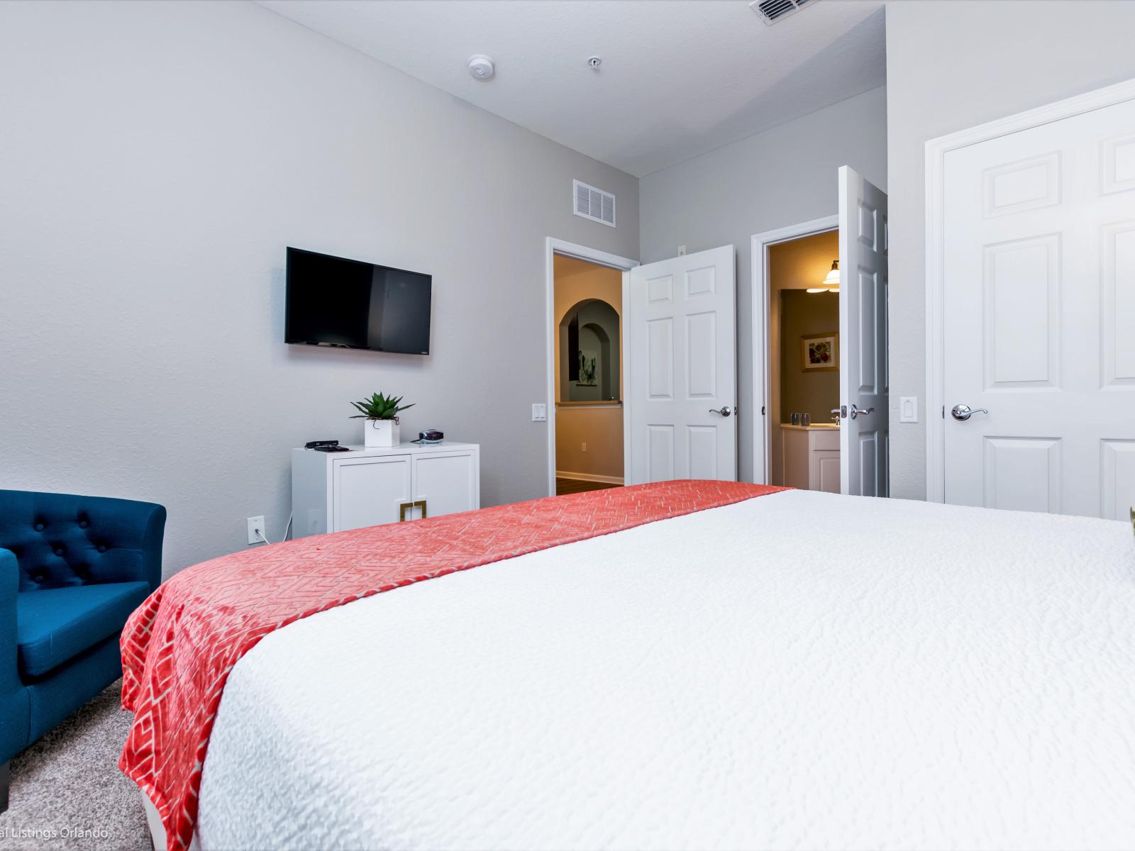 A spacious bedroom featuring a comfy bed, inviting you to relax and unwind in comfort.