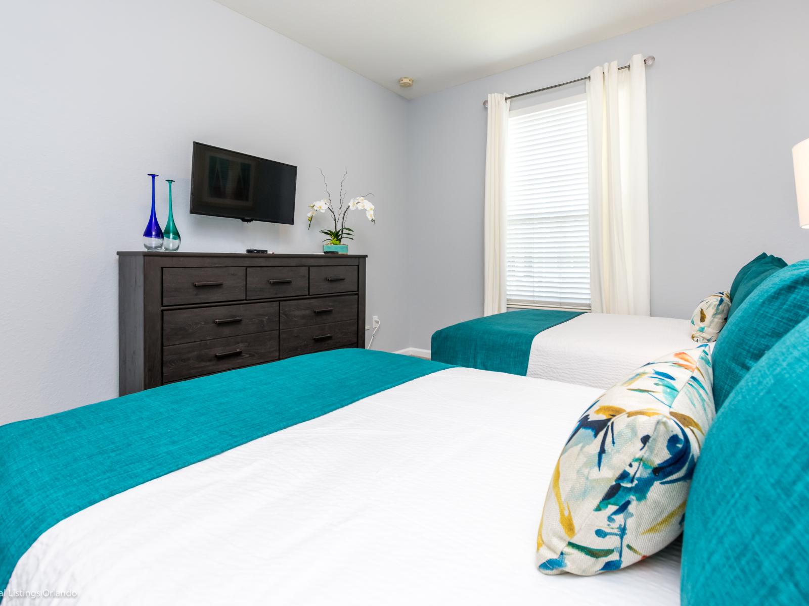 This  two-bed bedroom offering comfort and relaxation for a peaceful night's rest.