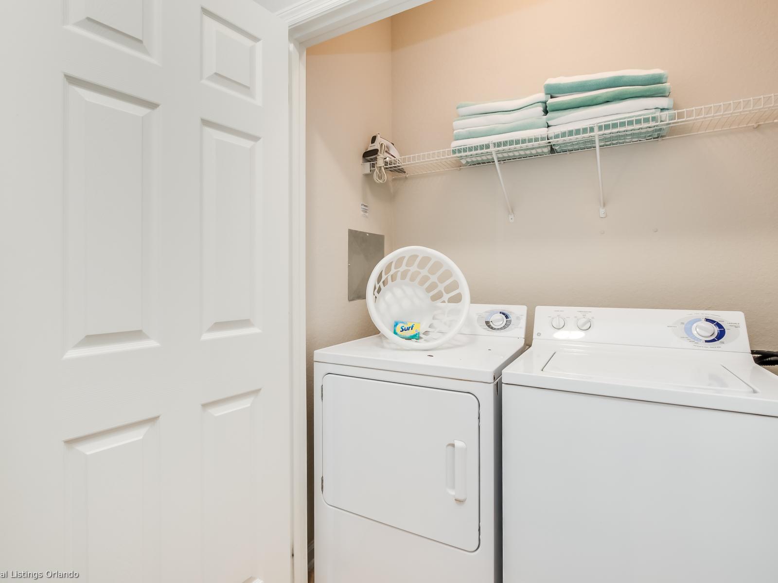 The laundry area boasts a full-size washer and dryer, ensuring that you can easily keep your clothes fresh and clean throughout your stay.