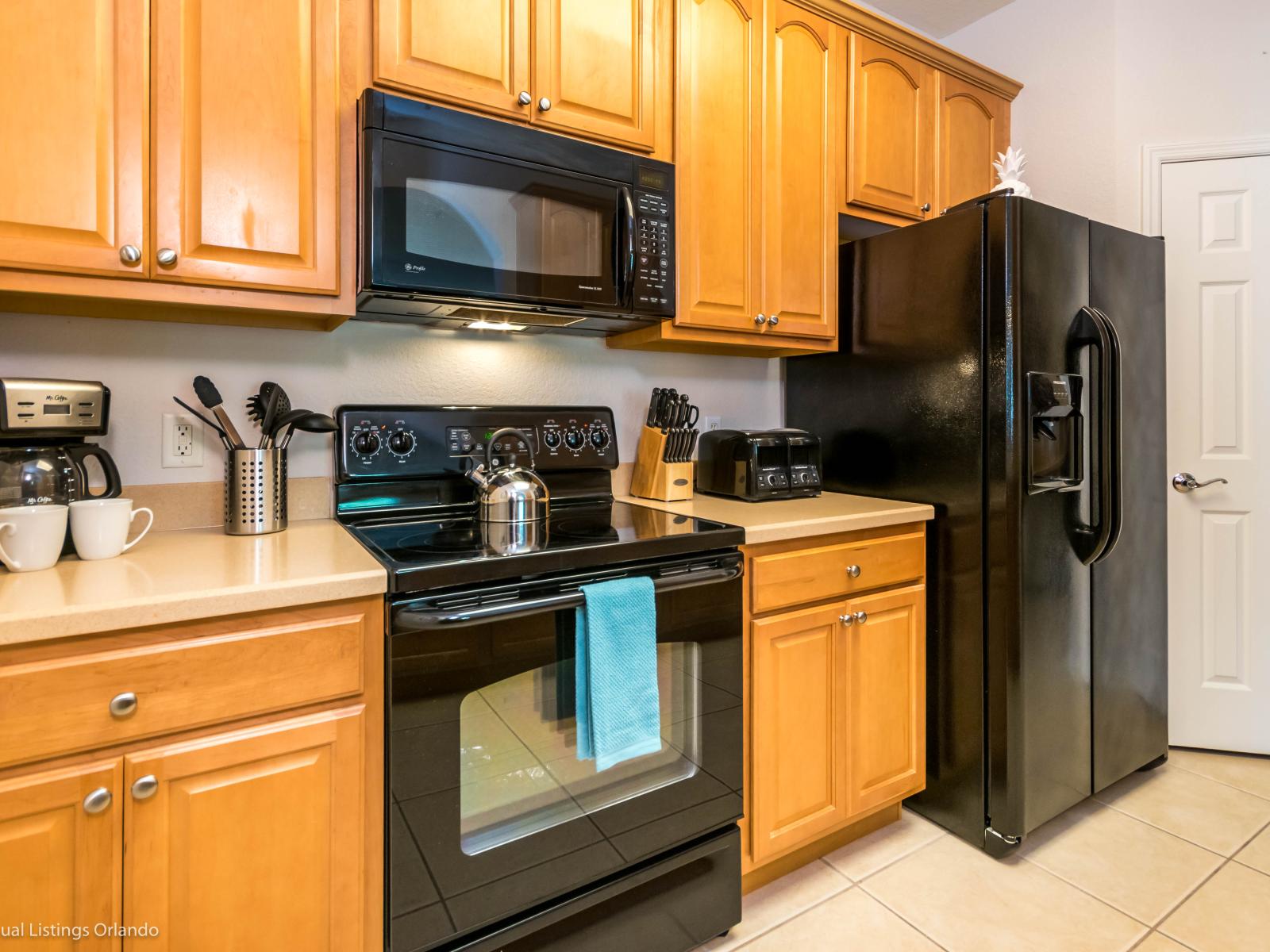 Tranquil Kitchen of the condo in Orlando Florida - Modern kitchen with sleek, stainless steel appliances - Contemporary design with clean lines and minimalist aesthetics - Integrated appliances for a seamless and stylish look - Plenty of storage