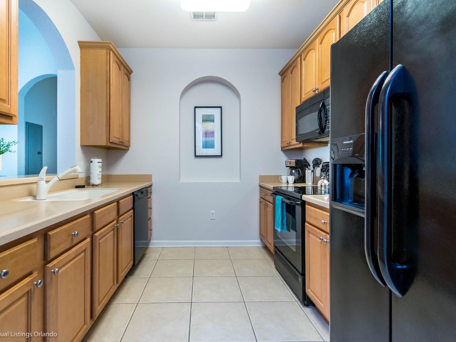 Polished kitchen of the condo in Orlando Florida - Thoughtful placement of kitchen essentials for easy access - Harmonious blend of practicality and contemporary aesthetics