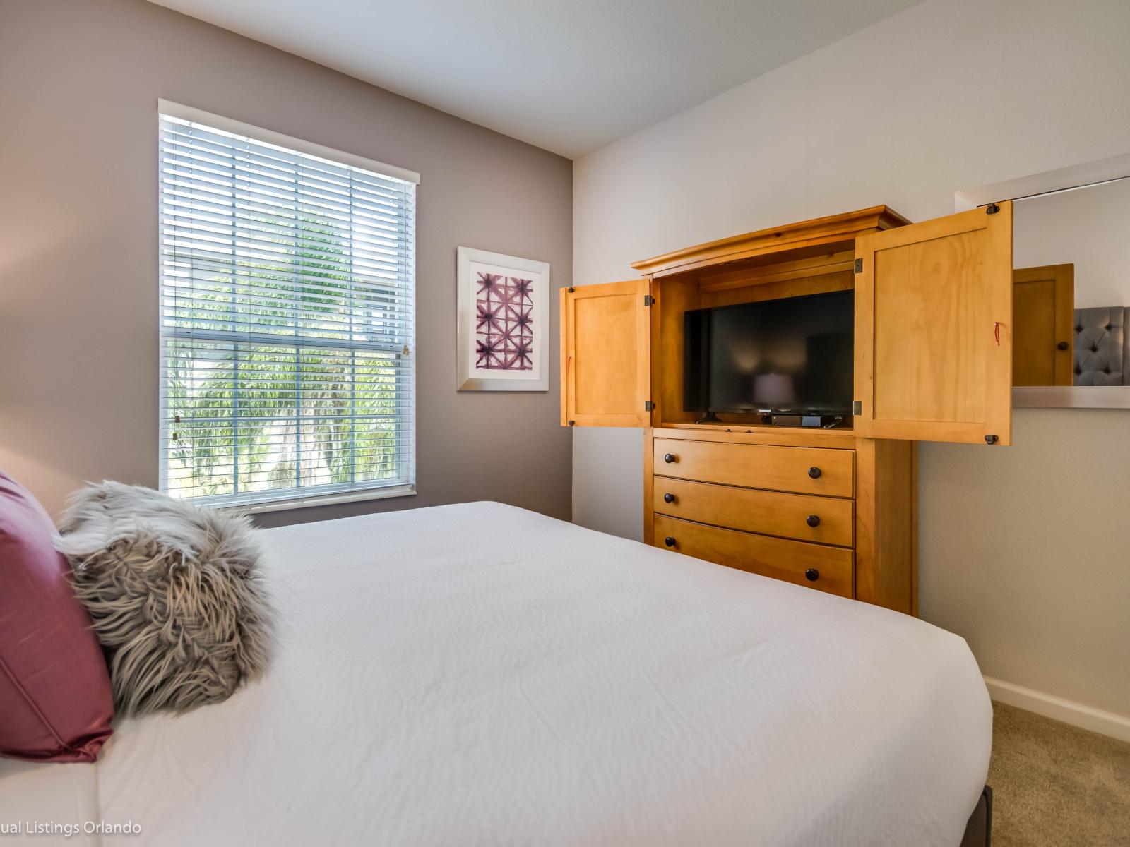 Picturesque Bedroom of the condo in Orlando Florida - Smart TV for entertainment - Thoughtfully designed bedroom featuring functional and stylish furniture - Minimalistic Approach giving clean space to relax