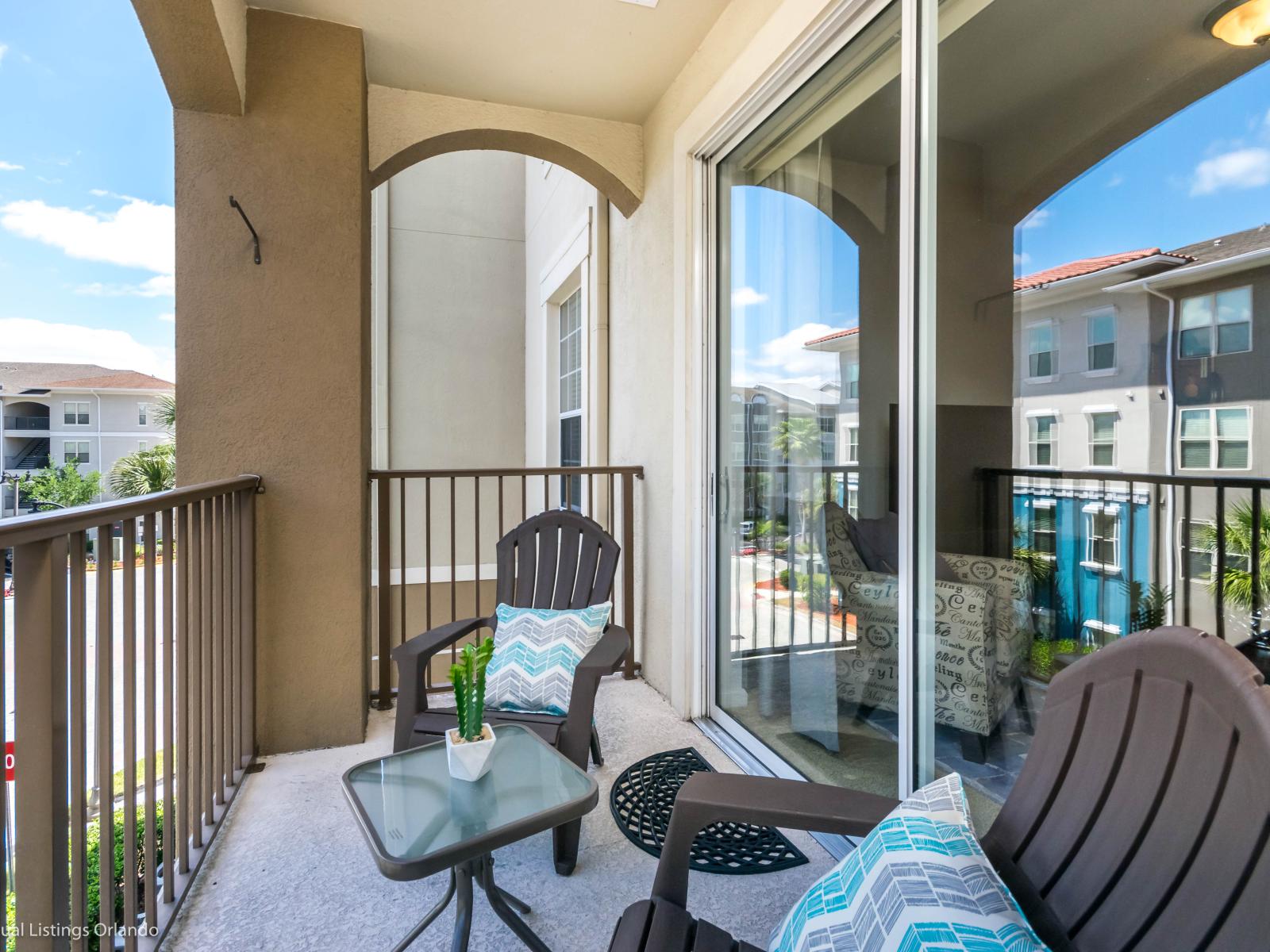 Scenic balcony of the condo in Orlando Florida - Cozy outdoor retreat with seating - Panoramic views of the surrounding area - Private oasis with a sense of tranquility